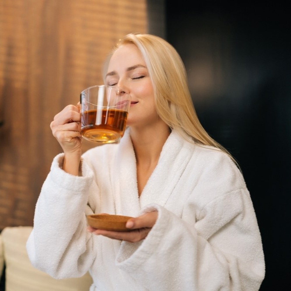 woman relaxing and drinking tea in med spa - U R Royalty - Cypress, Texas