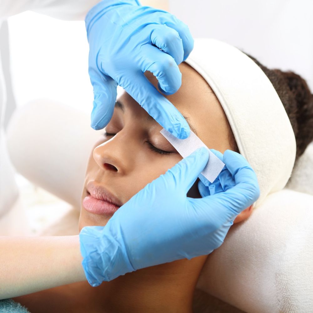 woman getting eyebrows waxed in med spa - U R Royalty - Cypress, Texas