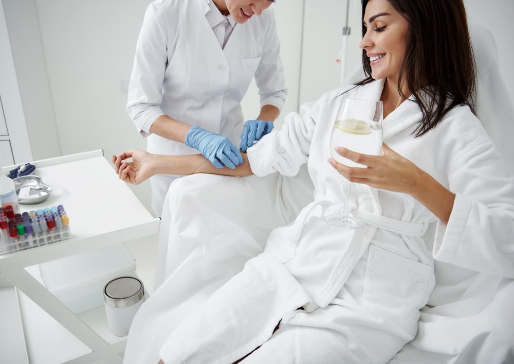 nurse inserting iv drip into woman's arm - U R Royalty - Cypress, Texas